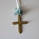 Metal golden cross with blue flowers