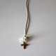 Small metal golden cross with white flowers