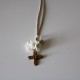 Small metal golden cross with white flowers