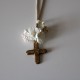 Small metal golden cross with white flowers