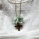 Small metal golden cross with green flowers