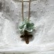 Small metal golden cross with green flowers